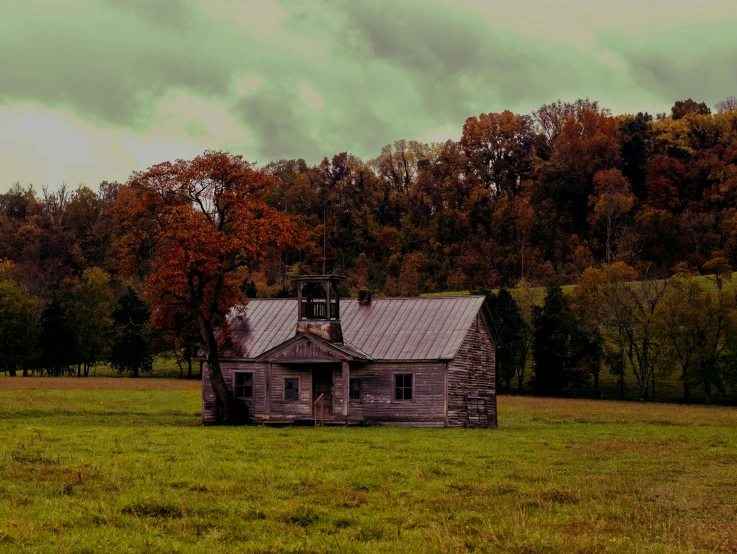 an old, lonely house in the middle of a field