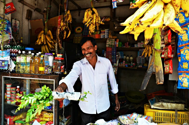 the man has his hands in some food at the stand