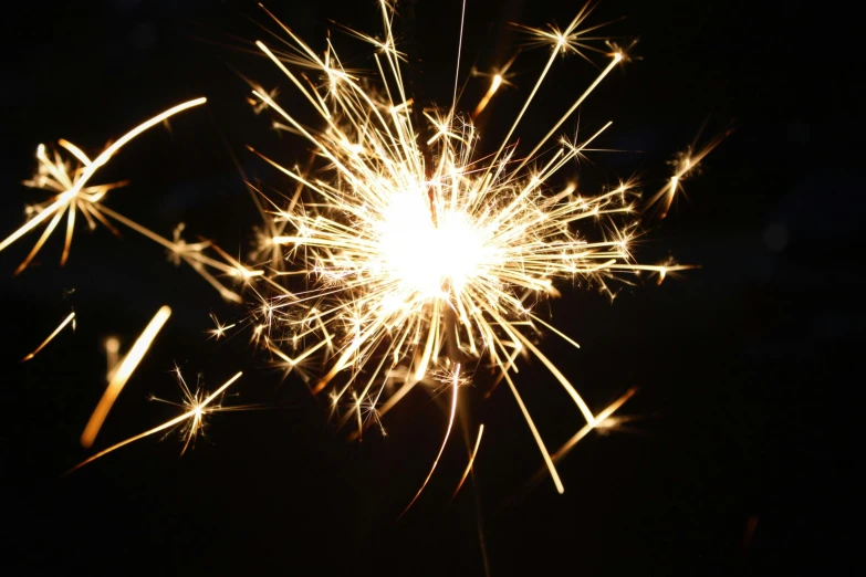 a sparkler is shown against the dark background
