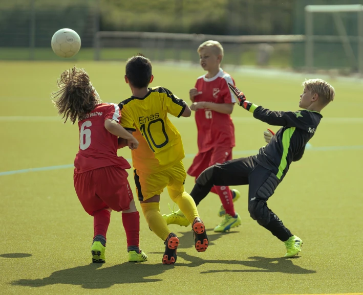 a soccer player goes for the ball with his teammates