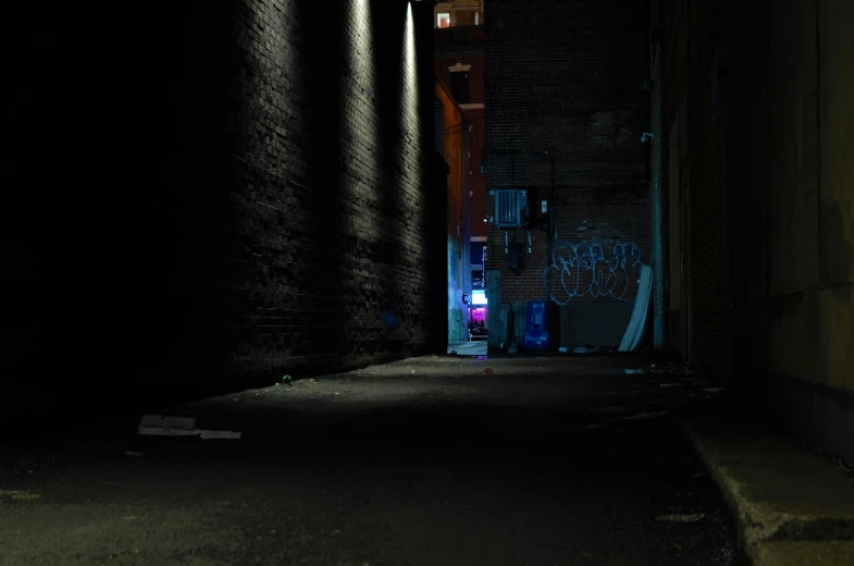 dark alley way with stop light and graffiti on walls