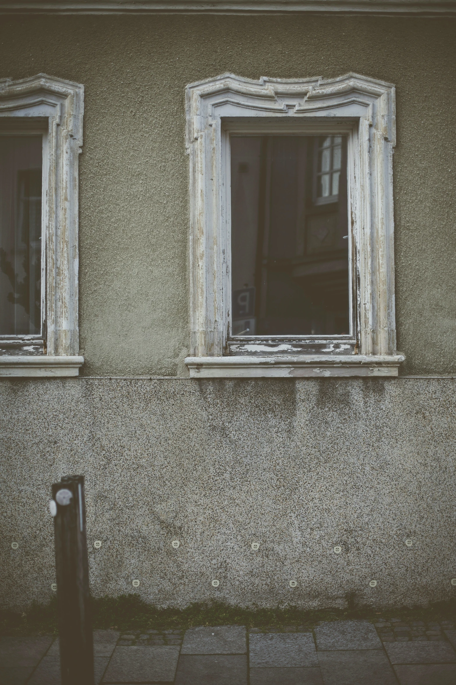 the windows are closed on the stucco wall