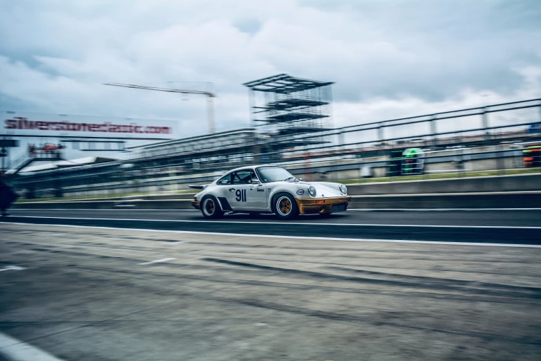 a white race car going around a track