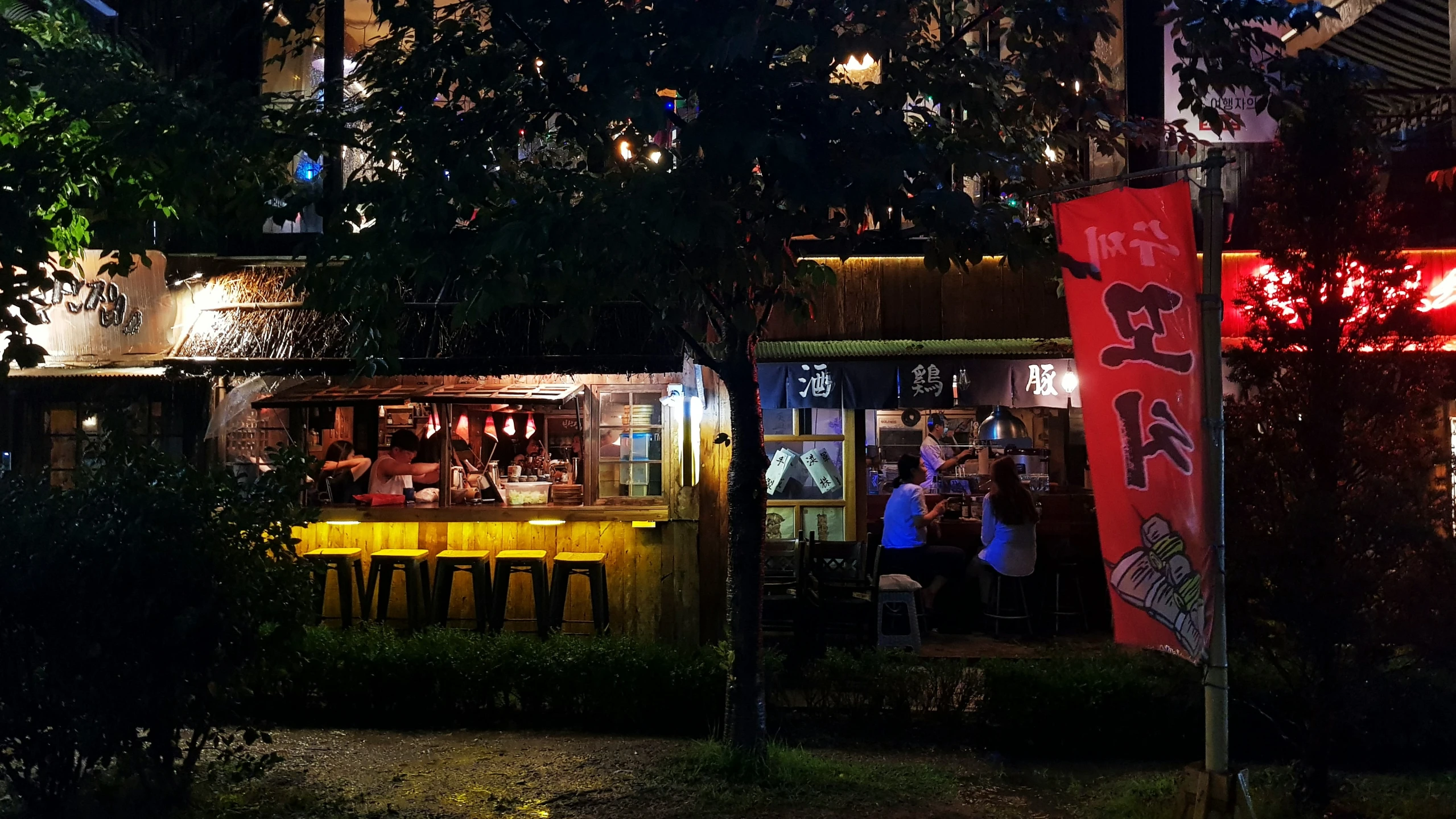 a city with chinese signs and lights at night