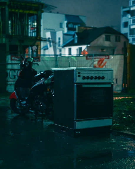 a small motor bike parked next to an oven