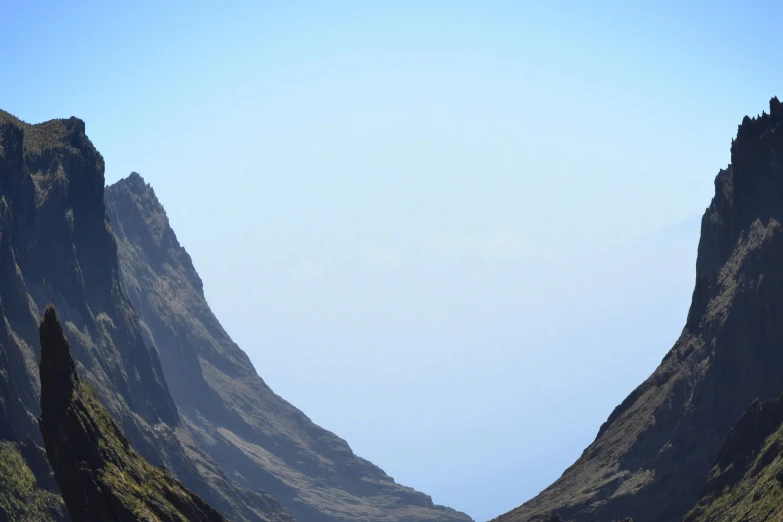 two mountain ranges are shown with some water near them