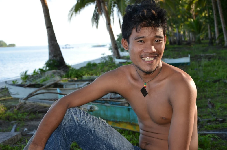 a guy is posing for a picture in front of some boats