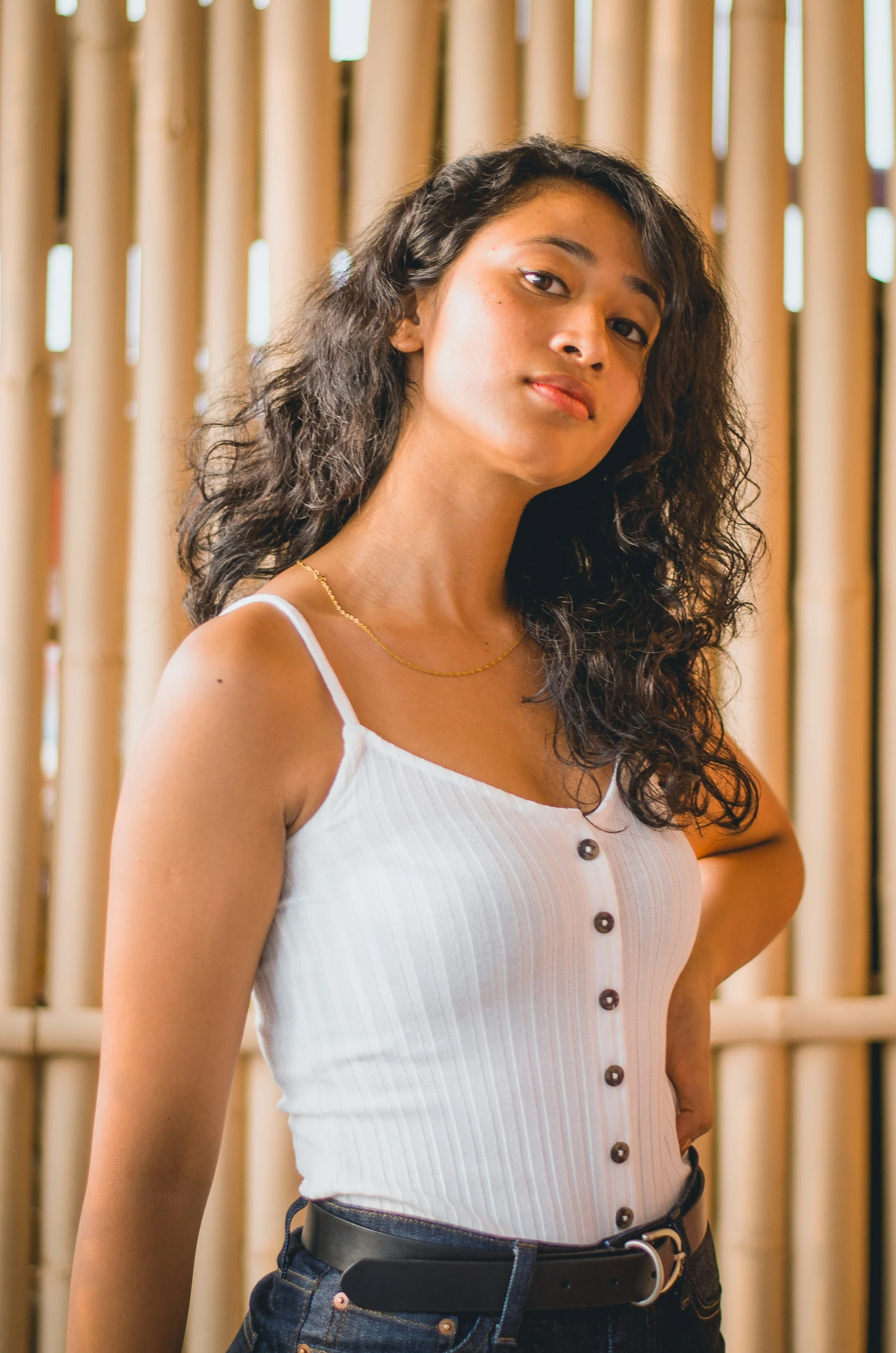 a young woman poses for the camera wearing a white crop top