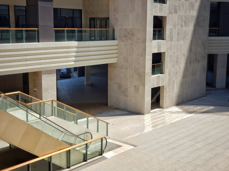 an atrium with railing and steps leading to a building