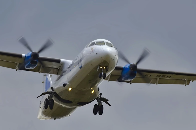an airplane with propellers taking off from an airport