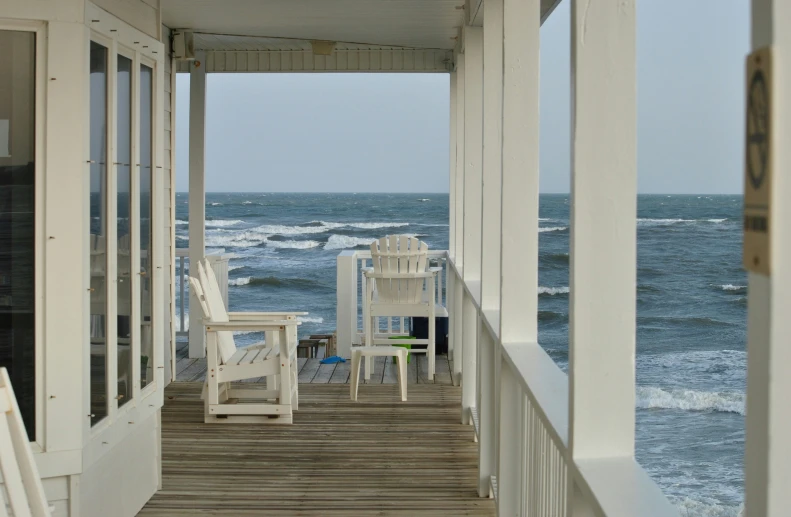 some chairs that are sitting on a wooden deck