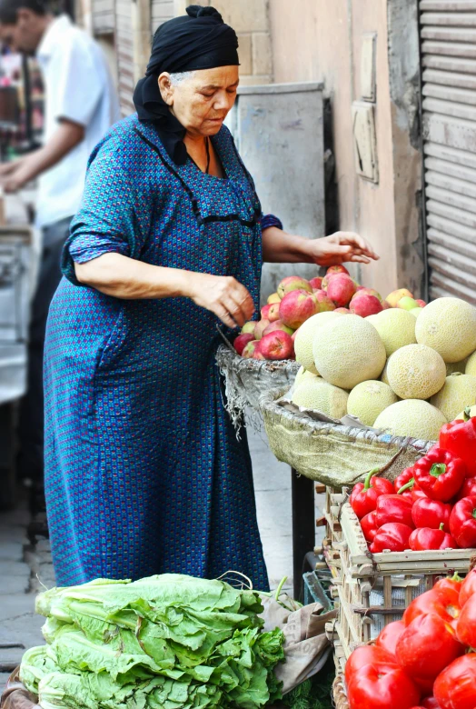 an older woman shops for fruits and vegetables