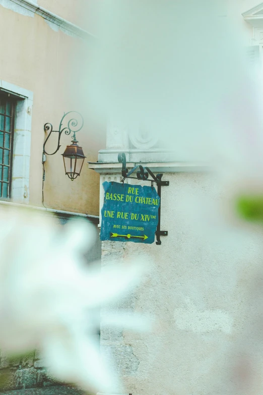 a blue sign attached to the side of a building