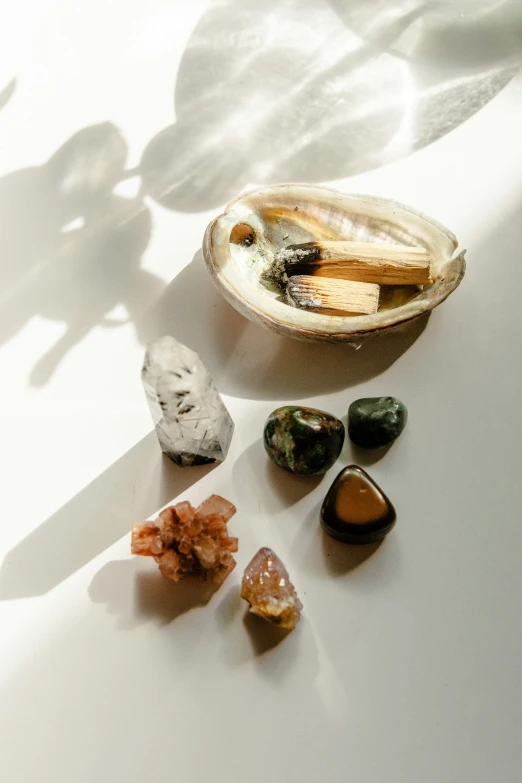 various rocks layed on a table top with shadows