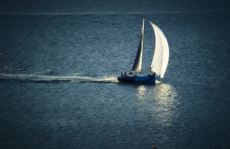 sailboat in large body of water on sunny day