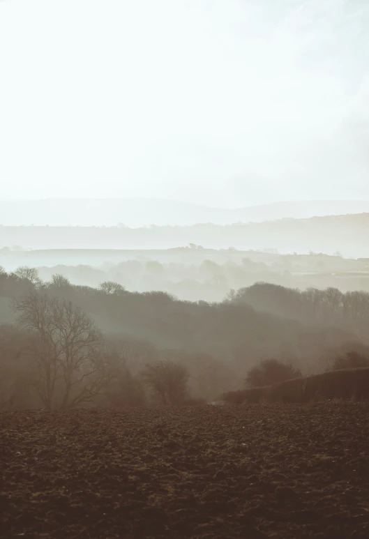 fog covers the landscape near some distant hills