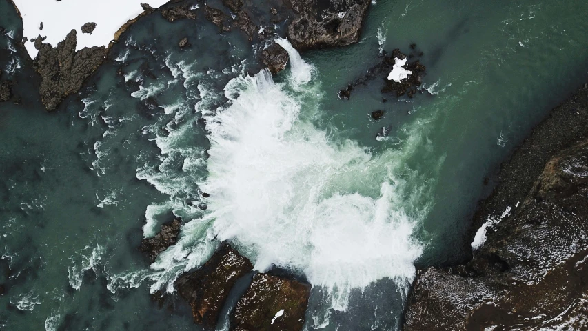 an aerial view of a body of water with waves in it