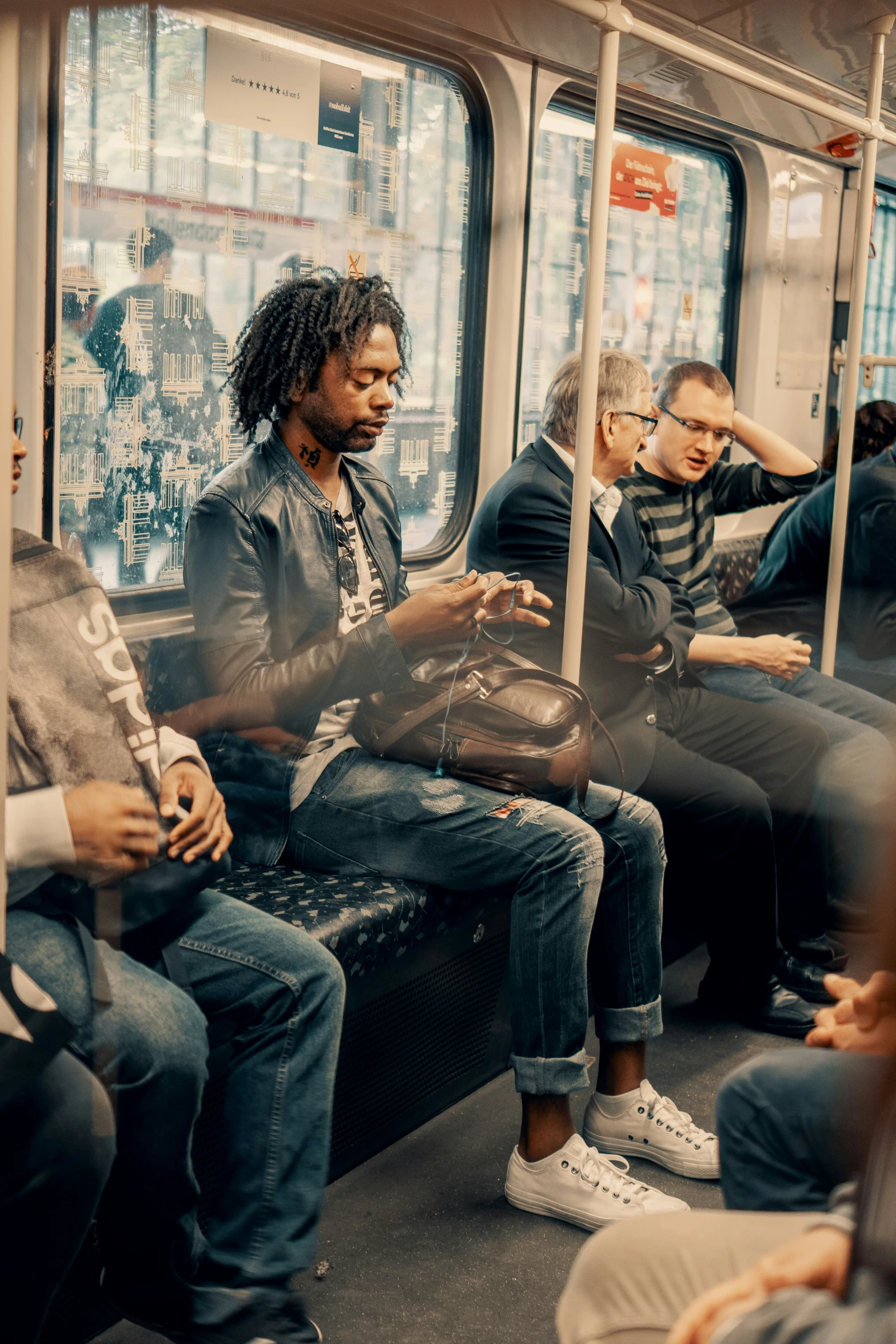 people are sitting and standing on a public bus