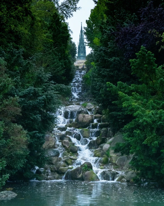 a waterfall in a river surrounded by trees