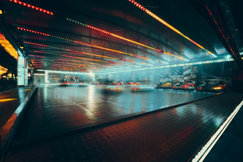 cars moving along a rainy city street at night