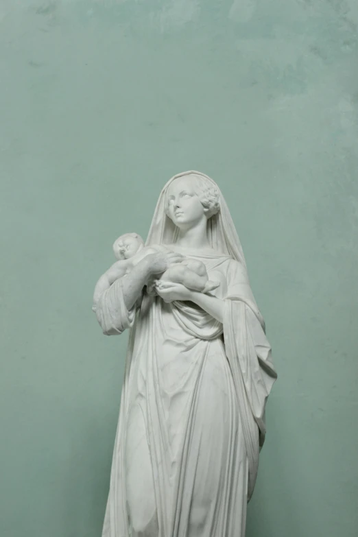 a white statue with a baby in her arms