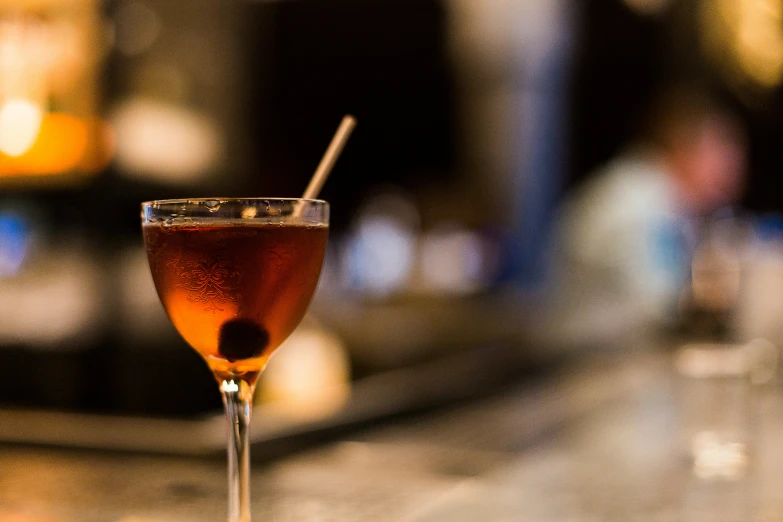 a glass of drink sitting on a table