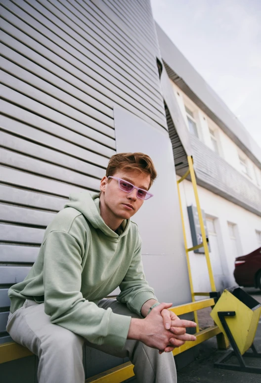 a man sitting on the side of a building