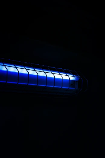 a very big bright blue tube in the dark