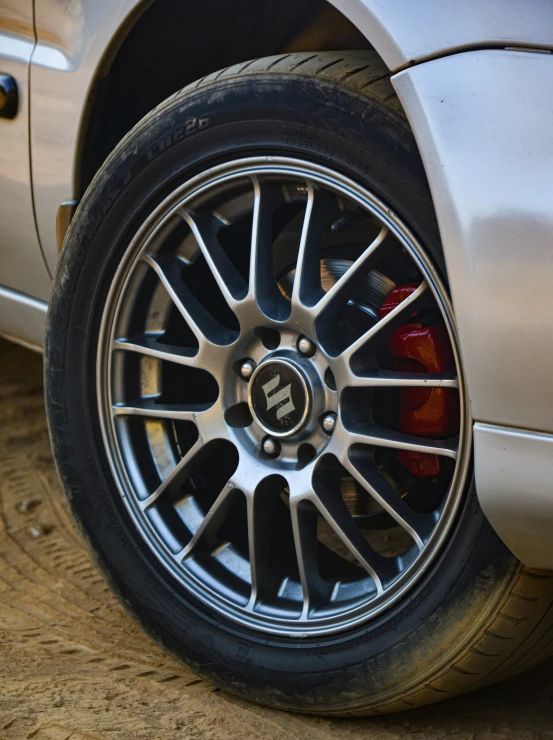 the wheel on a car that is parked on the street