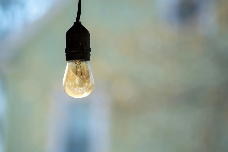 a light bulb is suspended from a wire