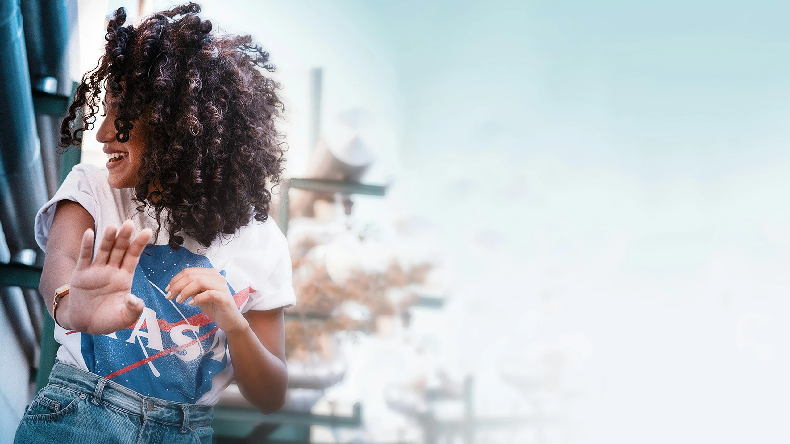 a person standing outside with her hand out