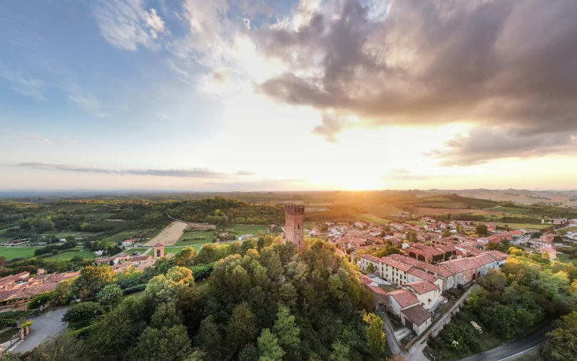 a city surrounded by trees and sunset