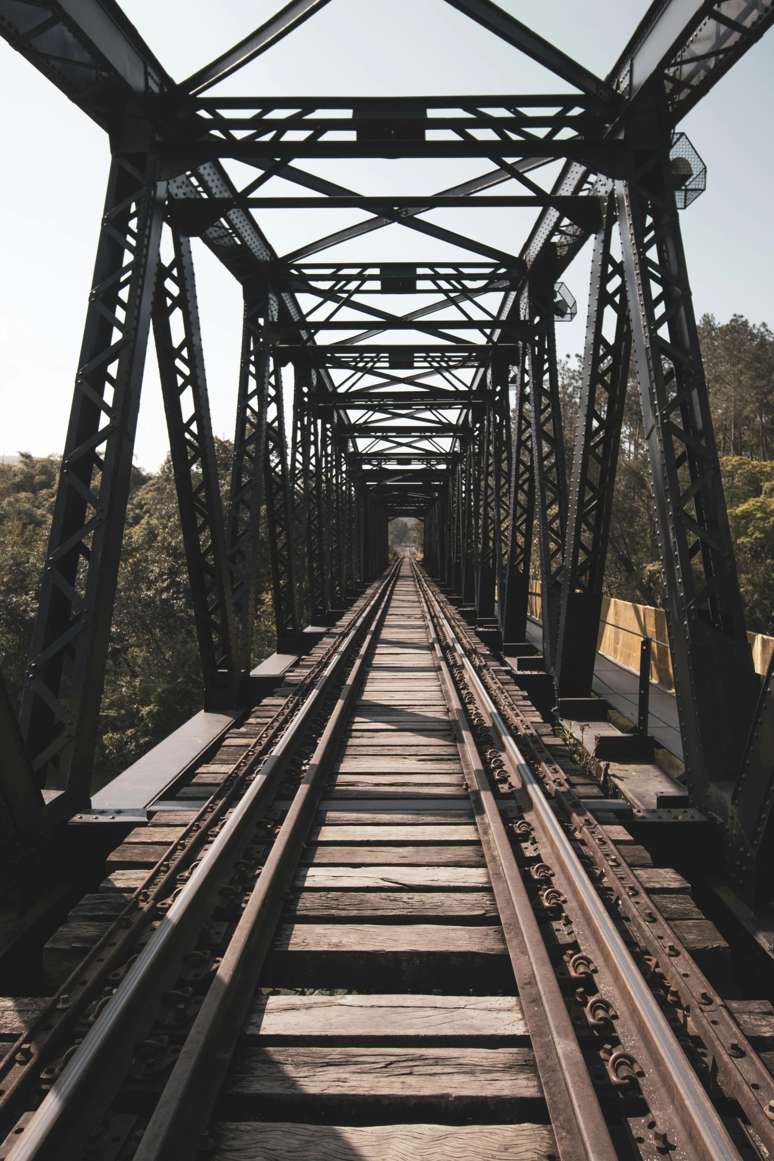 a large bridge spanning over train tracks into the distance