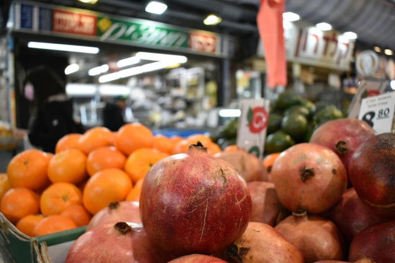 pomegranates, oranges and other fruit at a store