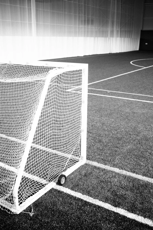 a small soccer ball inside of the goal