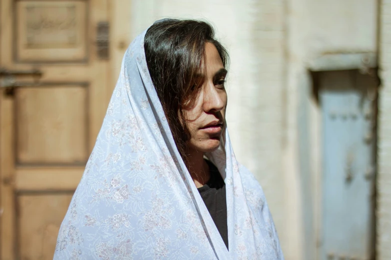 a woman is wrapped in a sheet looking ahead