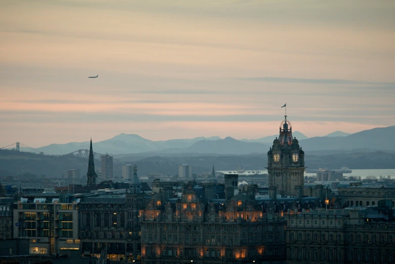 a clock tower in the middle of a large city