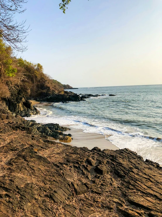 some rocks on the shoreline of a lake