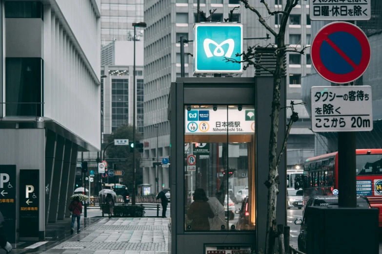 a bus stop sitting in the middle of a busy city street