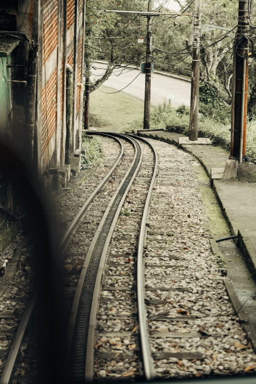 the train tracks run along an abandoned building