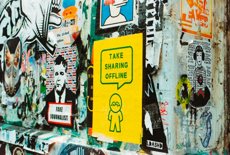 various stickers on a metal wall with a man in the center