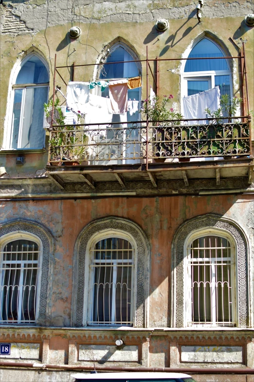 two windows of a multi story building and a laundry line