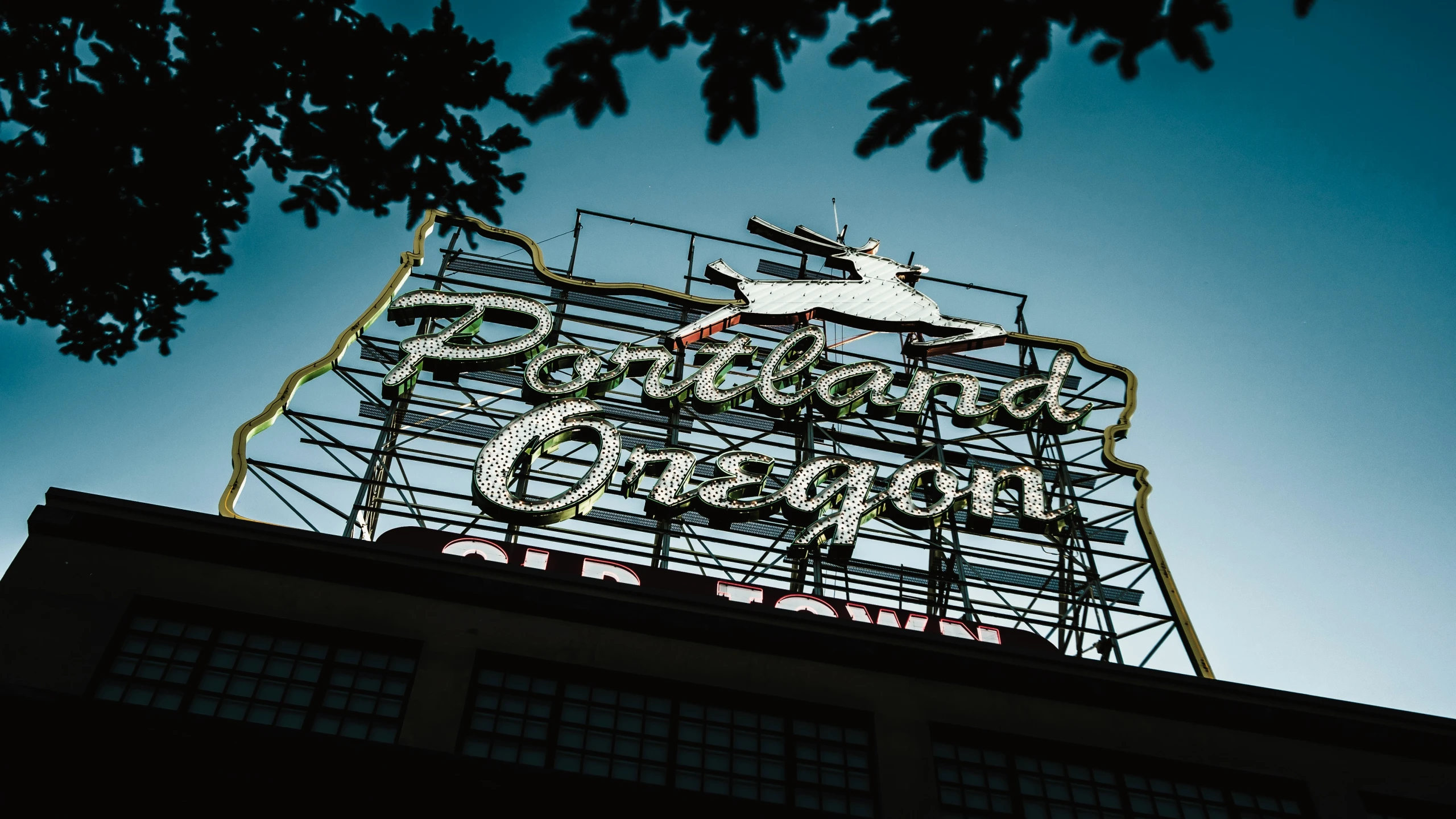 the large sign on top of a building in front of trees