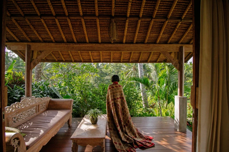 a person standing at an outdoor covered porch