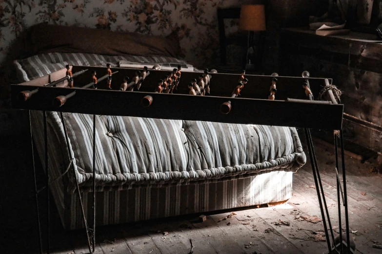 an old bed in a dimly lit room with flowers on the wall