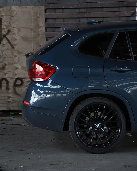 a blue vehicle parked next to a wooden building