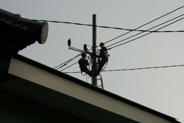 a couple of people are working on some wires