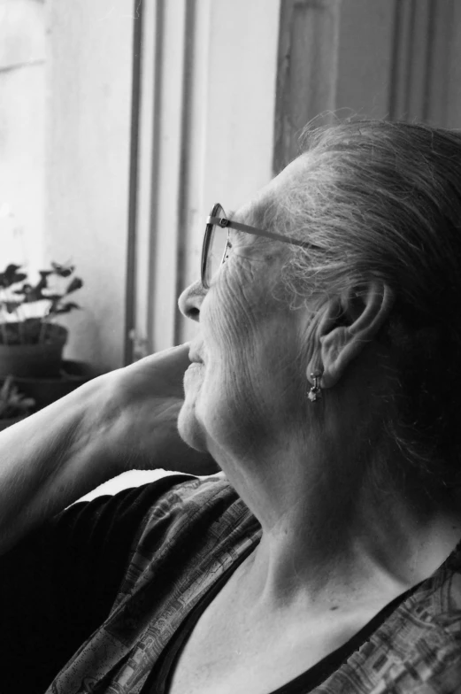 an elderly woman is smiling and holding her hair