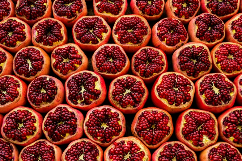 many pomegranates are shown stacked on top of each other