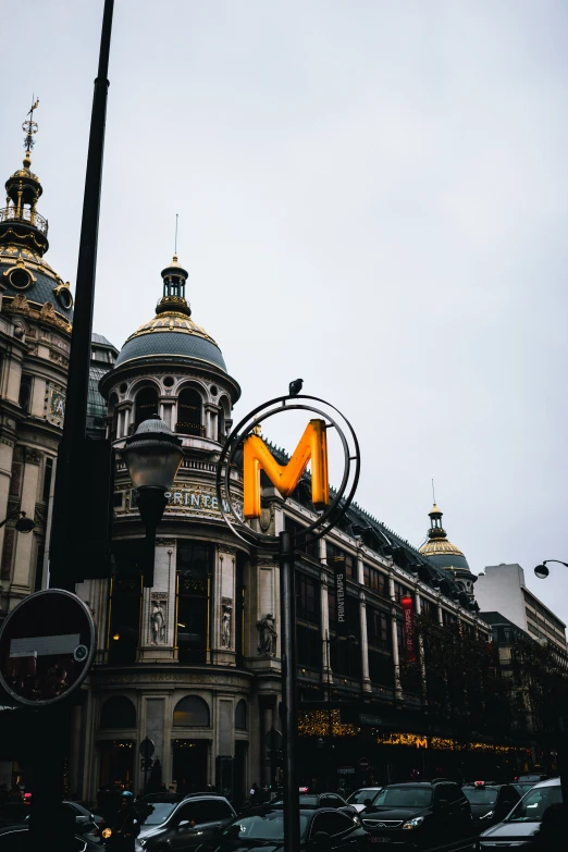 the illuminated sign says m on a building